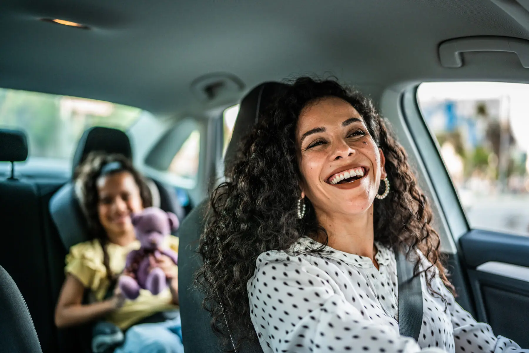 mother and daughter talking in car