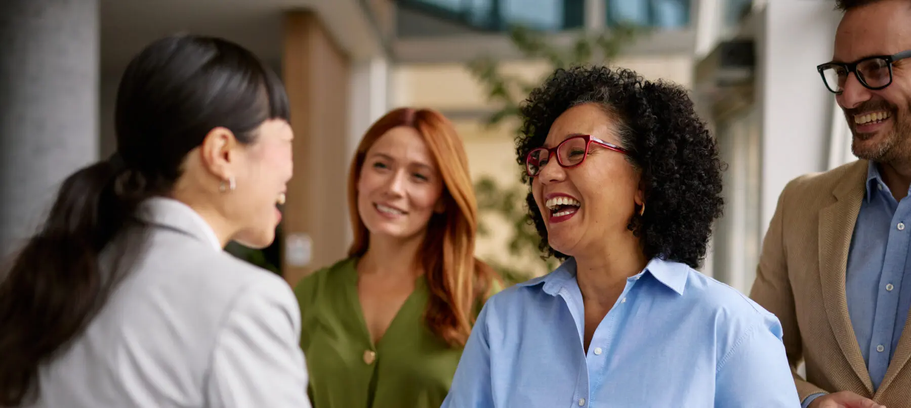 group of diverse business colleagues engaged in a friendly handshake in a modern office setting