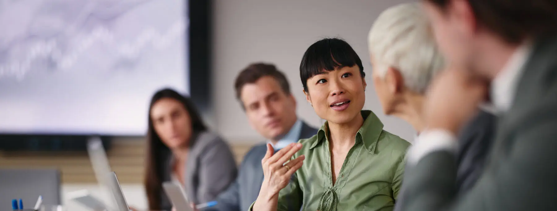 business woman speaking to her colleagues in a conference room