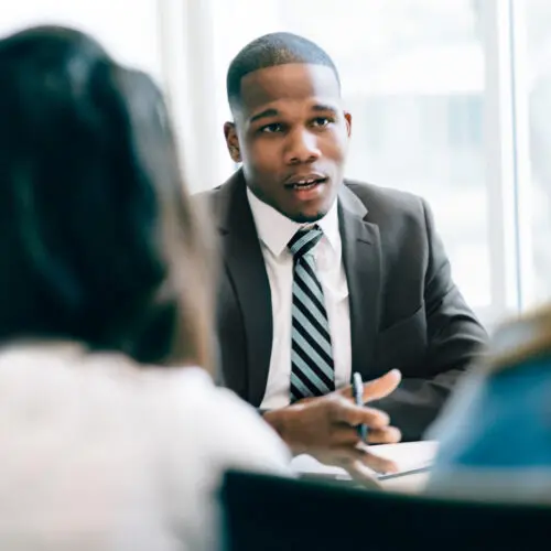 business man speaking clients in an office