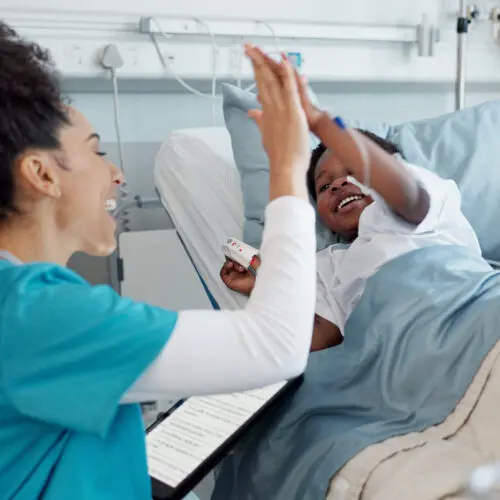 child pediatrician and high five in hospital